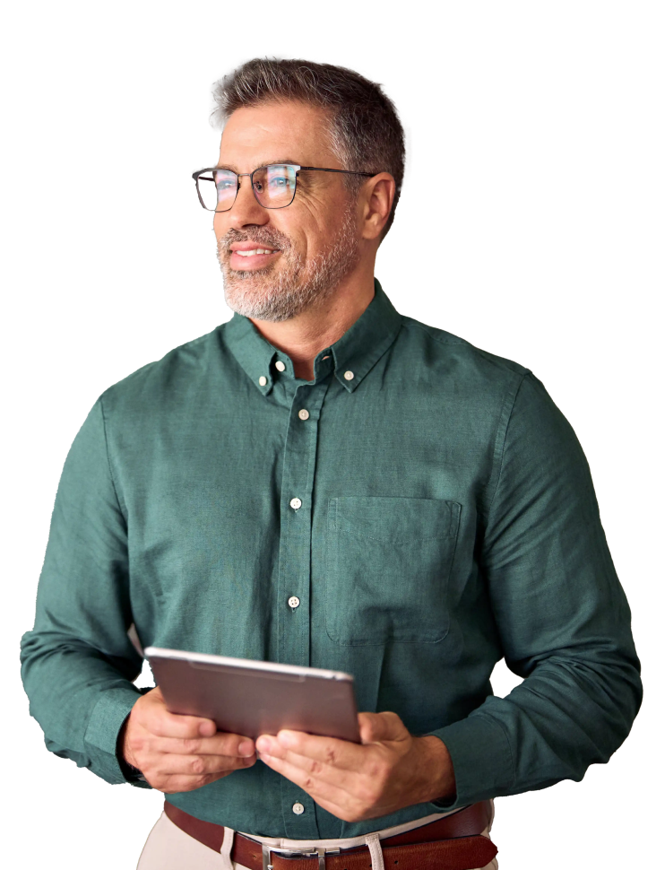 A man with short gray hair and a beard is wearing glasses, a green button-down shirt, and brown pants. He is standing while holding a tablet, looking off to the side with a thoughtful expression, as if contemplating impressive pitch decks. The background is plain white.