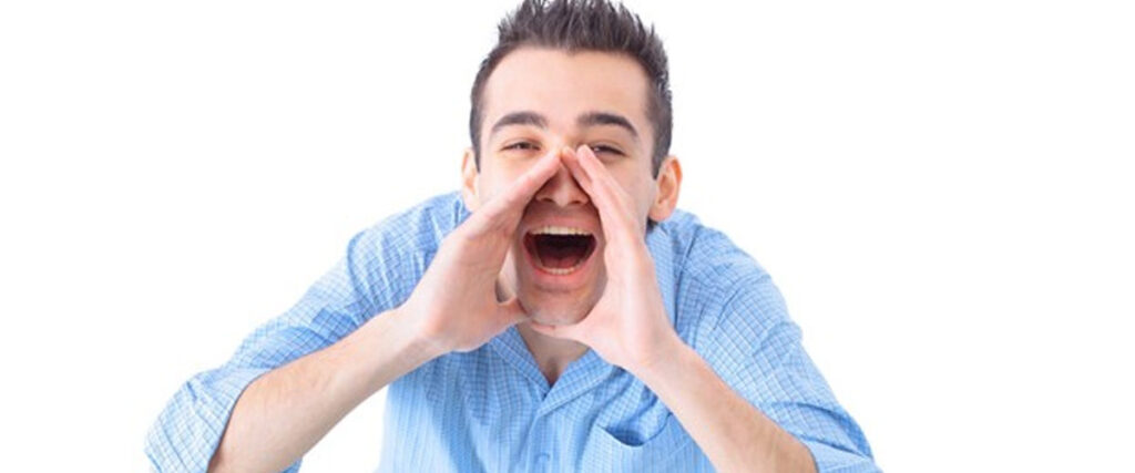 A person with short dark hair, dressed in a light blue shirt, is shouting or calling out with hands cupped around their mouth. Their expression is enthusiastic, making it perfect for a dynamic PowerPoint presentation slide. The background is plain white.