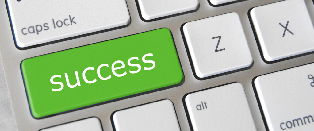 Close-up of a computer keyboard featuring a green key with the word "success" written on it. This green key replaces the usual "enter" key, and the surrounding keys are white with typical labels like "caps lock" and letters such as "Z" and "X," making it perfect for your next slide template.