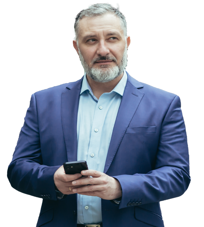 A man with short gray hair and a beard is wearing a blue suit and light blue shirt. He is holding a smartphone in both hands, possibly reviewing an investment presentation design, and looking slightly to his left. The background is white, isolating the subject.